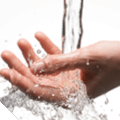Closeup woman hand under the stream of splashing water - skin care concept